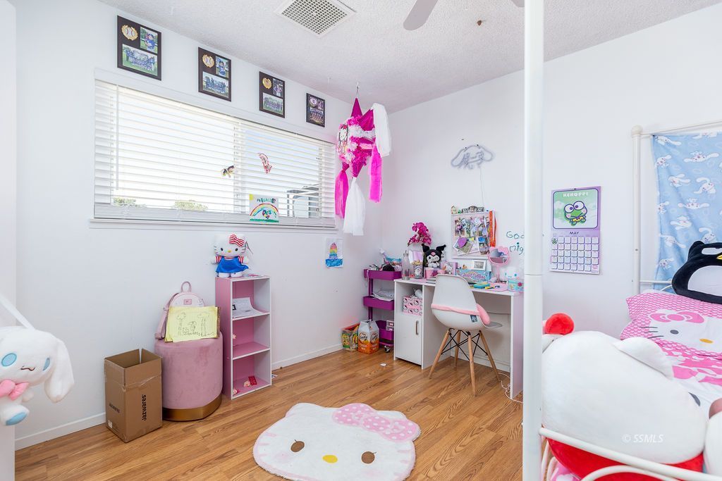 328 Peg Street Ridgecrest, CA 93555 - Photo 14 of 20 a bedroom with furniture and a bed