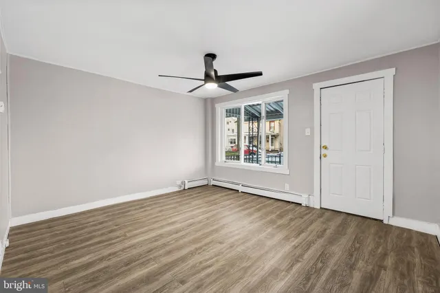 wooden floor in an empty room with a window