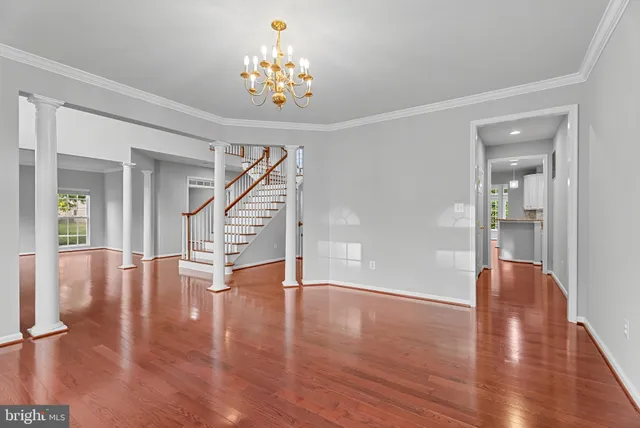 a view of an entryway with wooden floor and stairs