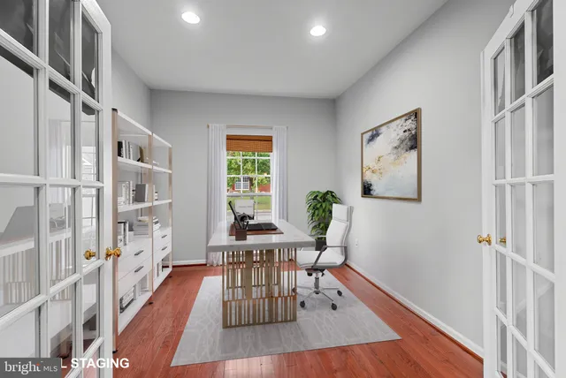 a view of a hallway with wooden floor and furniture