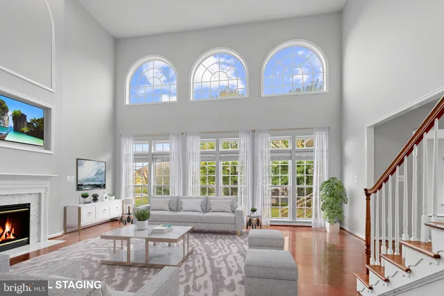 a living room with furniture a fireplace and a large window