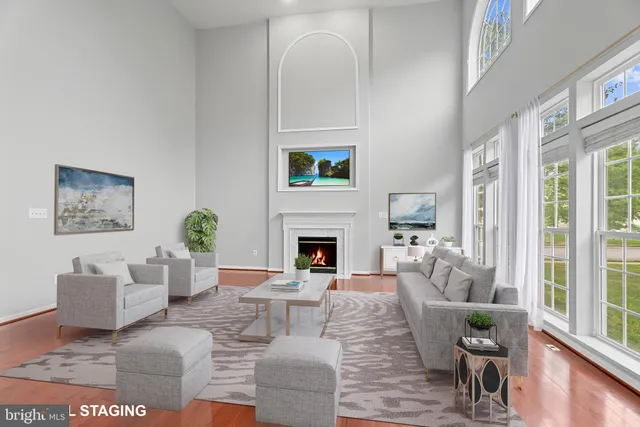 a living room with furniture a fireplace and a table