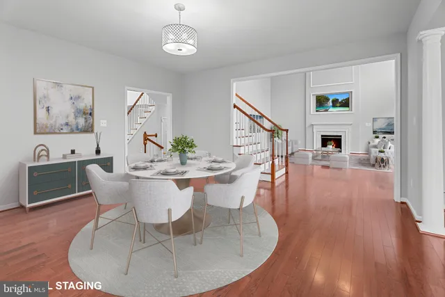 a view of a dining room with furniture wooden floor and a chandelier
