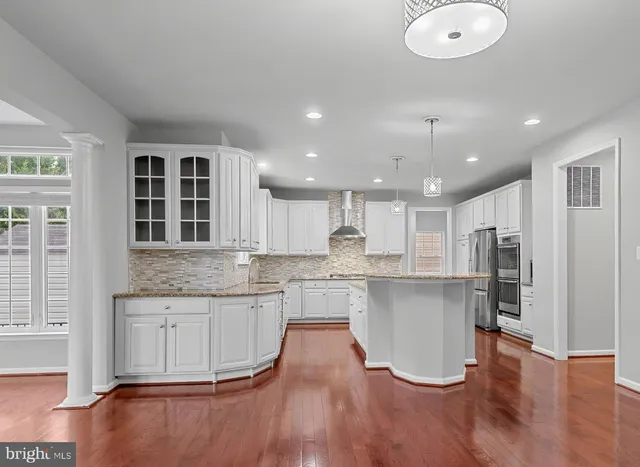 a kitchen with a sink appliances and cabinets