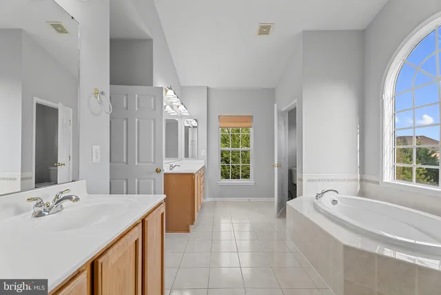 a spacious bathroom with sink shower and bathtub