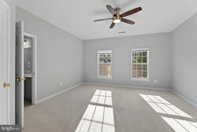 a view of an empty room with windows