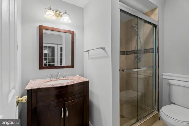 a bathroom with a toilet a sink and shower