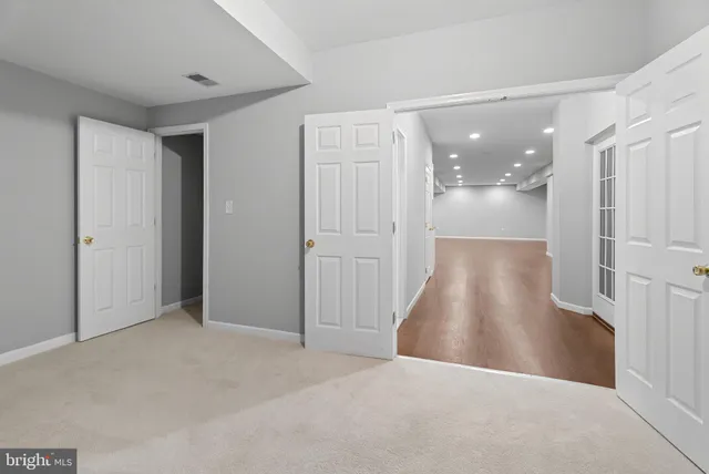 a view of a big room with wooden floor and mirror