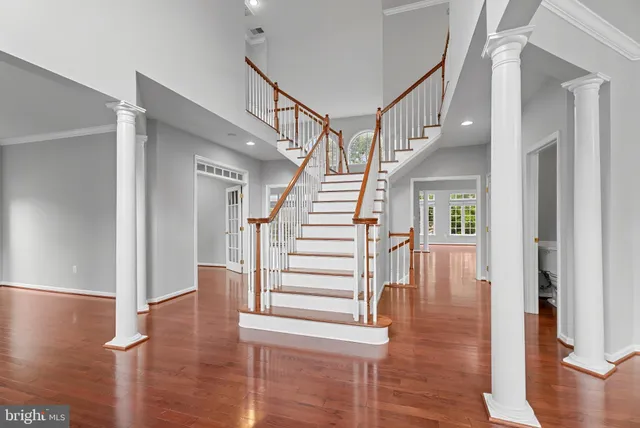 a view of entryway and hall with wooden floor