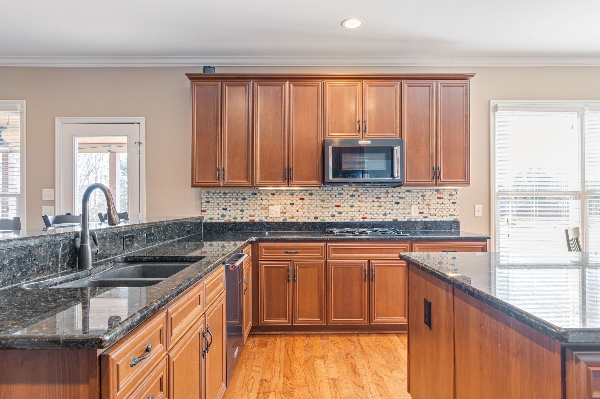 3517 Union Village Road Thompson's Station, TN 37179 - Photo 26 of 94 a kitchen with granite countertop wooden cabinets a sink and a window