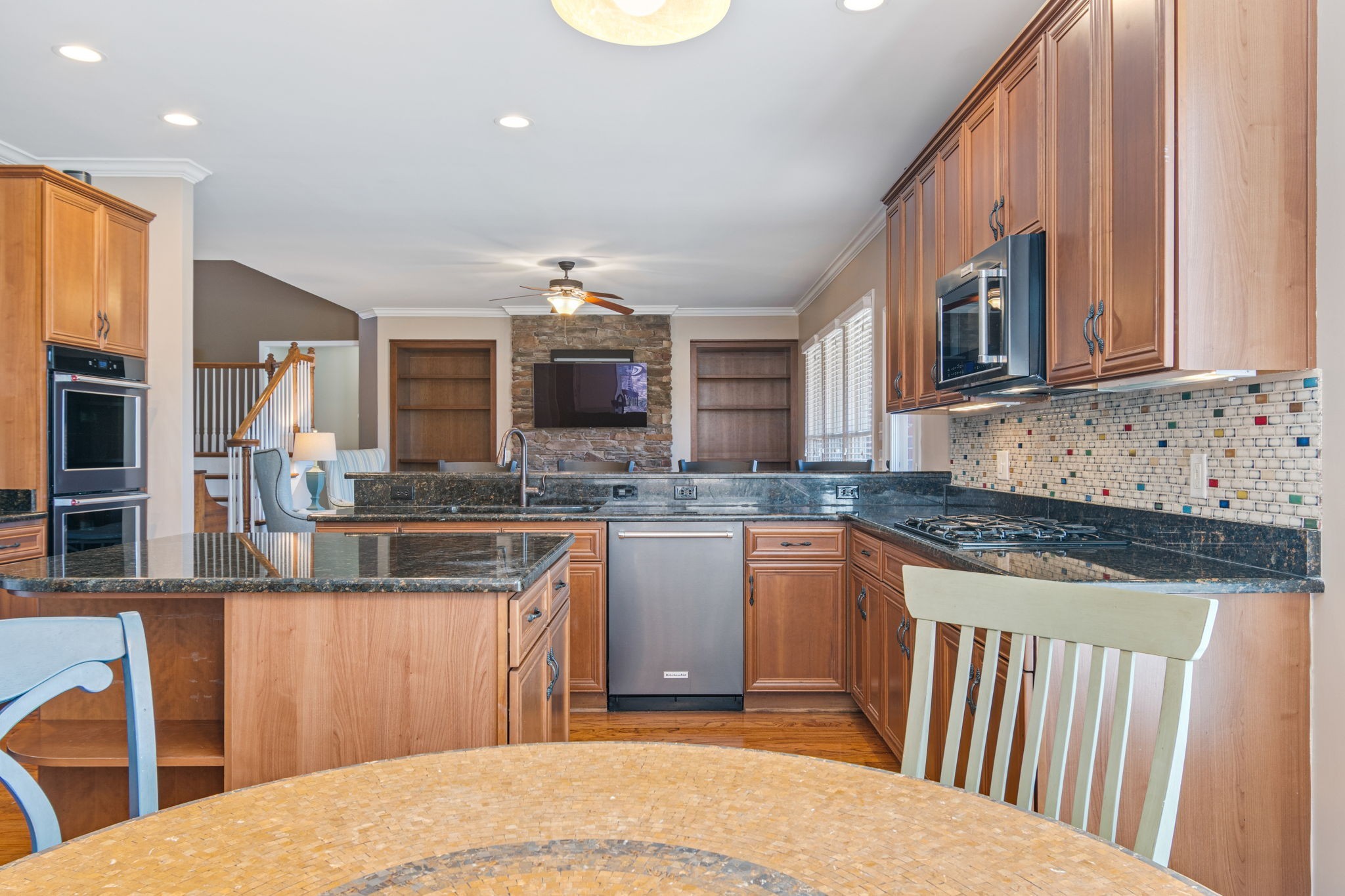 3517 Union Village Road Thompson's Station, TN 37179 - Photo 27 of 94 a kitchen with stainless steel appliances granite countertop a stove top oven a sink dishwasher a dining table and chairs with wooden floor