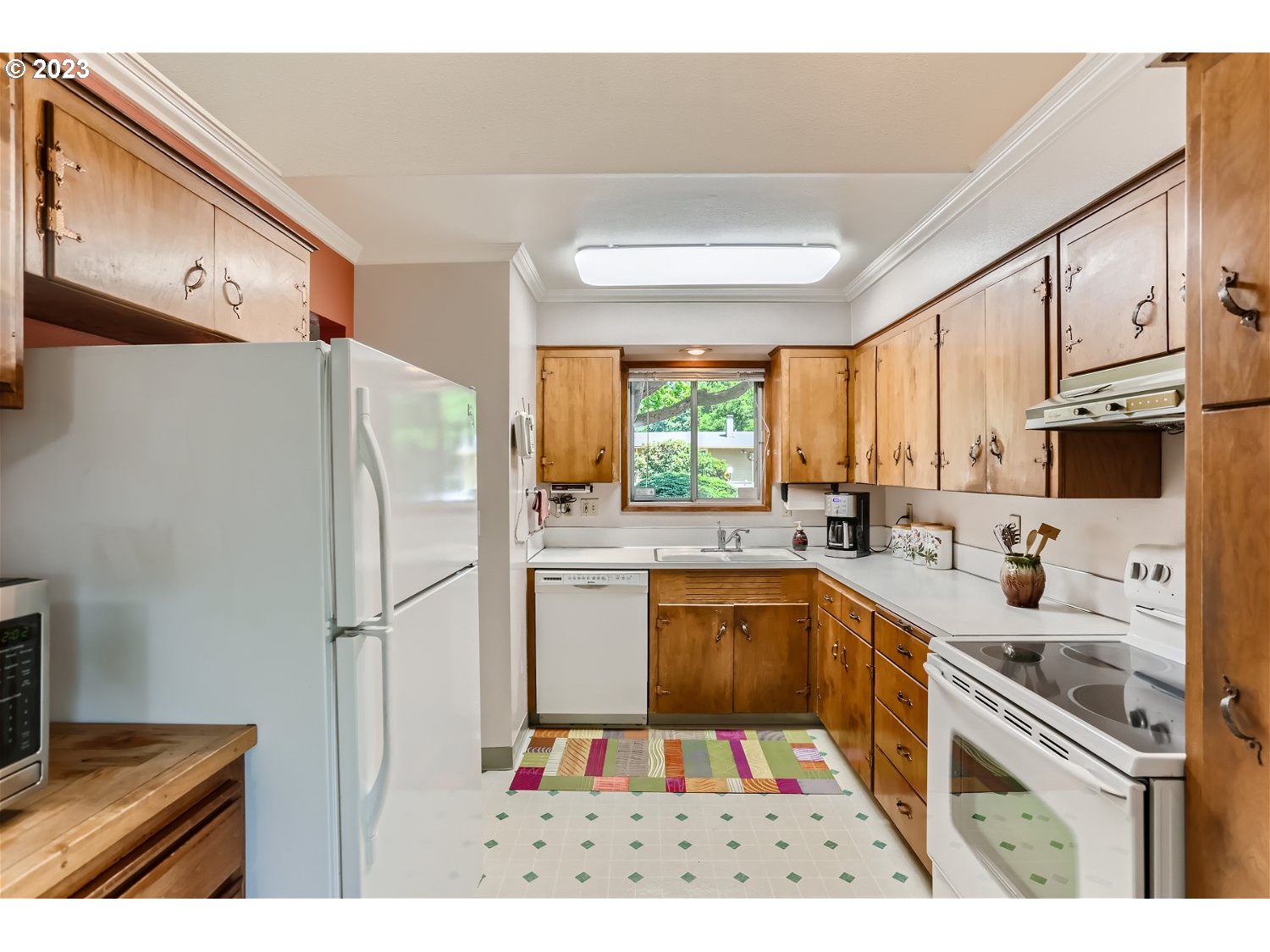 8220 Southwest Taylors Ferry Road Tigard, OR 97223 - Photo 11 of 38 a kitchen with stainless steel appliances a refrigerator sink and cabinets