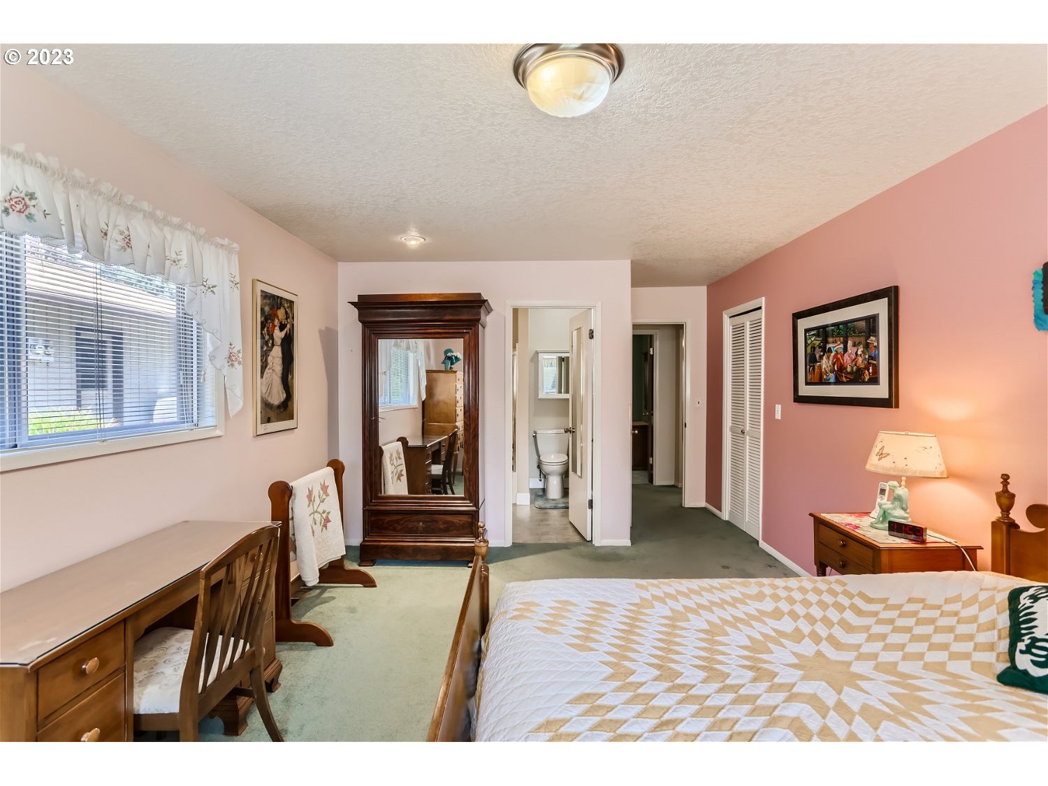 8220 Southwest Taylors Ferry Road Tigard, OR 97223 - Photo 15 of 38 a bedroom with a bed and a chandelier