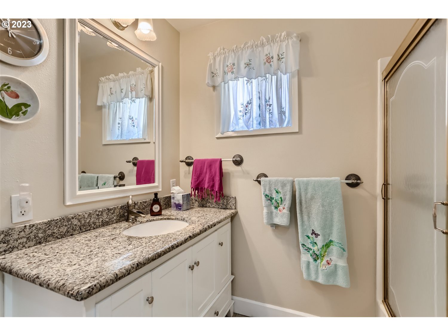 8220 Southwest Taylors Ferry Road Tigard, OR 97223 - Photo 17 of 38 a bathroom with a granite countertop sink and a mirror
