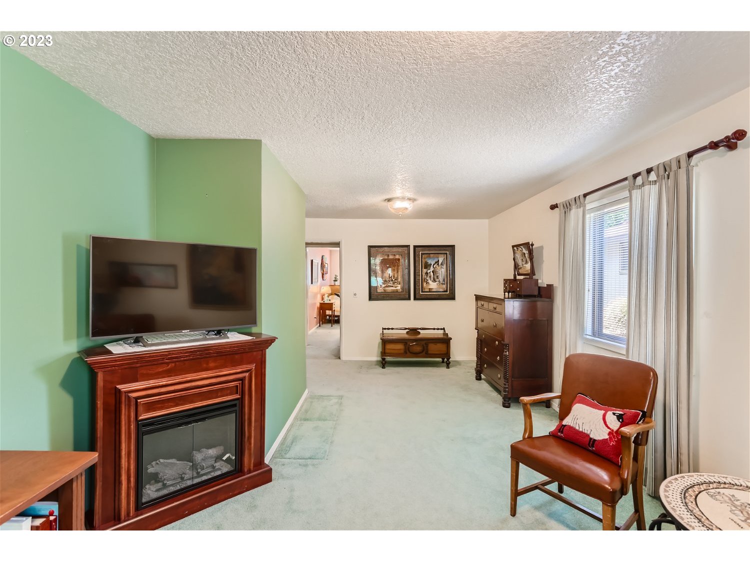 8220 Southwest Taylors Ferry Road Tigard, OR 97223 - Photo 19 of 38 a living room with furniture and a flat screen tv