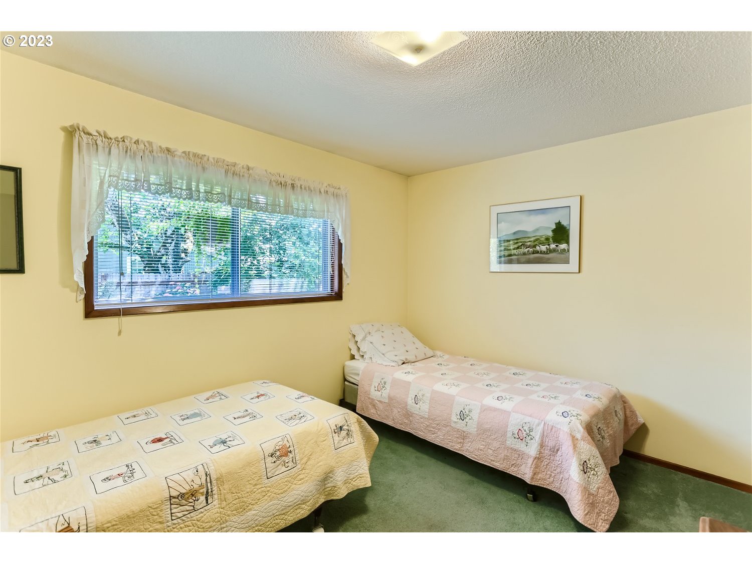 8220 Southwest Taylors Ferry Road Tigard, OR 97223 - Photo 21 of 38 a bedroom with a bed and a painting on the wall