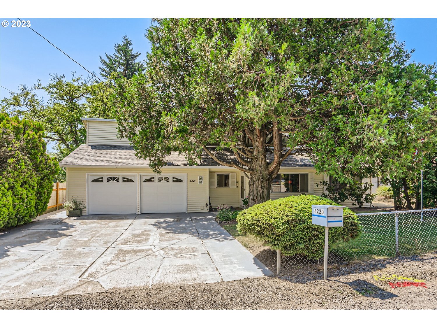 8220 Southwest Taylors Ferry Road Tigard, OR 97223 - Photo 3 of 38 a backyard of a house with table and chairs