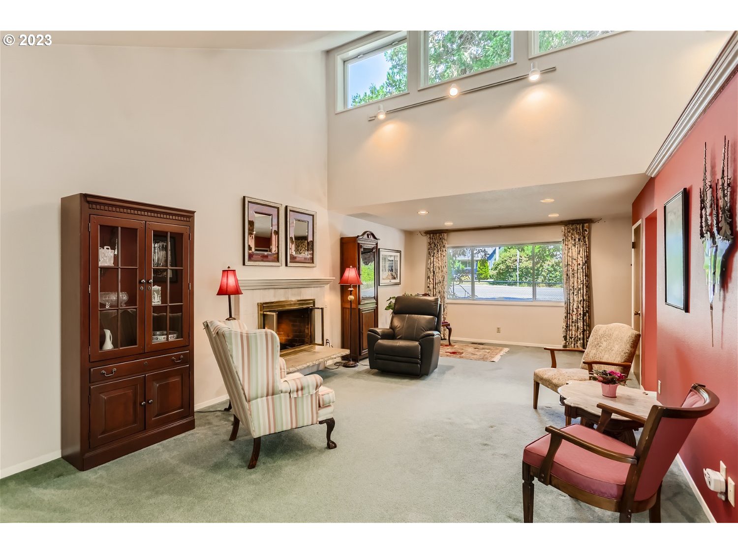 8220 Southwest Taylors Ferry Road Tigard, OR 97223 - Photo 6 of 38 a living room with furniture a fireplace and a large window