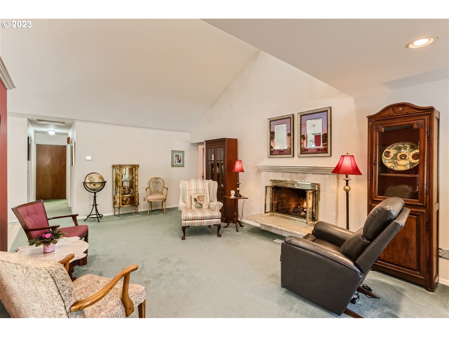 8220 Southwest Taylors Ferry Road Tigard, OR 97223 - Photo 8 of 38 a living room with furniture a fireplace and paintings on the wall