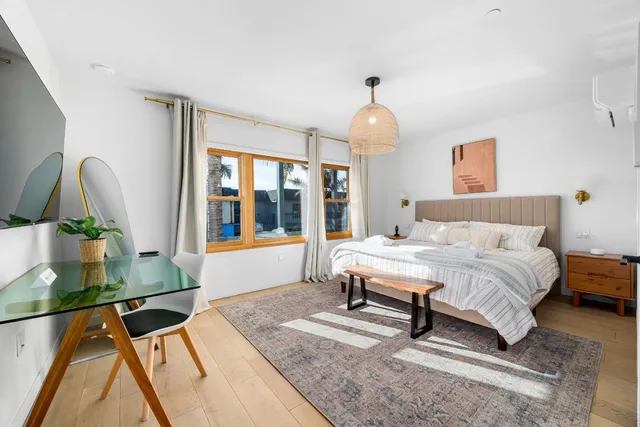 a bedroom with a bed and a large window