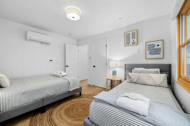 a bedroom with bed and a night stand