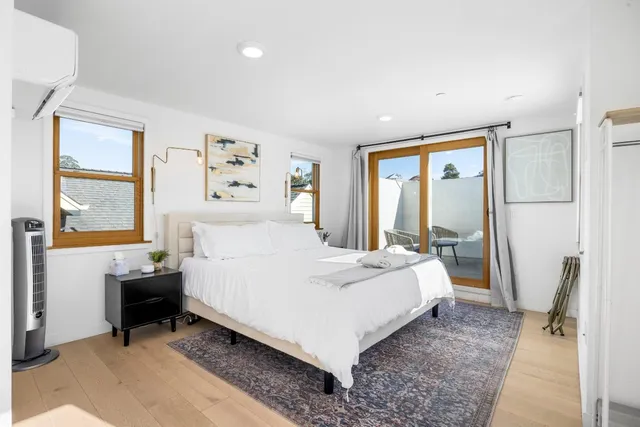 a bedroom with a large bed and a window