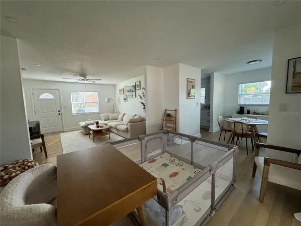 a living room with furniture and wooden floor