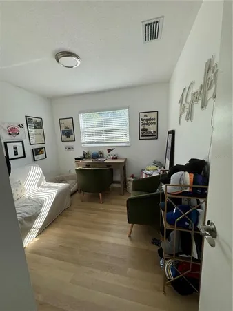 a view of a workspace with furniture and a window