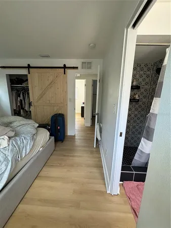 a bedroom with a bed and a couch