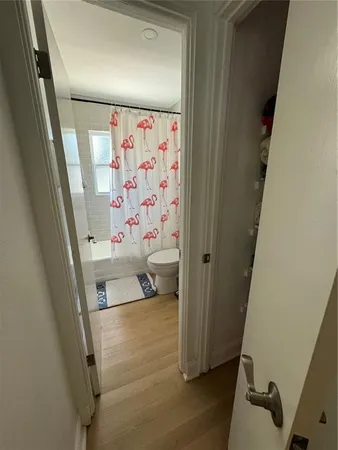a view of a hallway and wooden floor