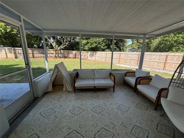 a view of a house with backyard and porch
