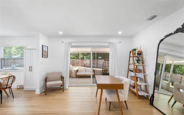 a living room with furniture and a floor to ceiling window