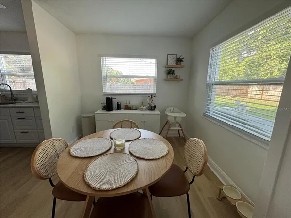 a view of a dining room with furniture and wooden floor