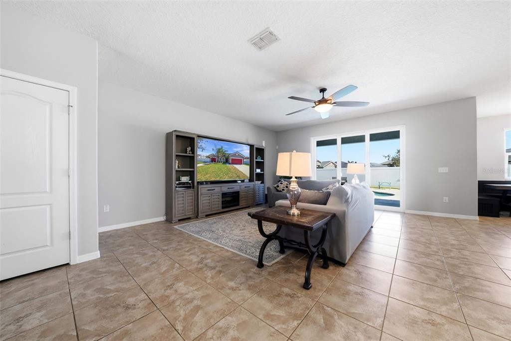 14604 Rannoch Moor Place Wimauma, FL 33598 - Photo 11 of 76 a living room with furniture and a flat screen tv