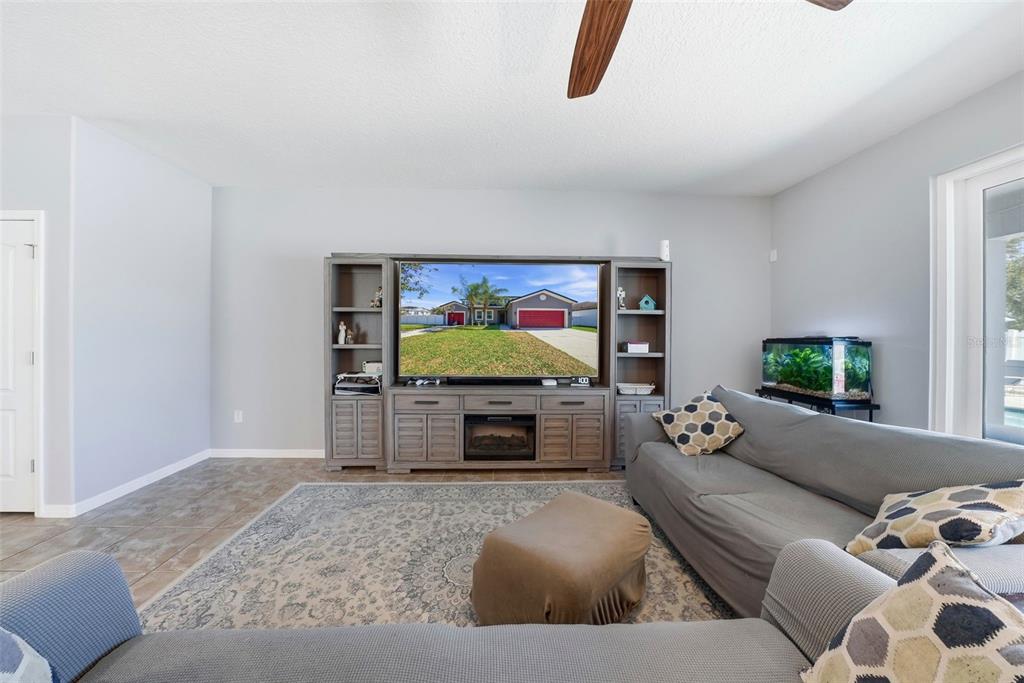 14604 Rannoch Moor Place Wimauma, FL 33598 - Photo 12 of 76 a living room with furniture and a flat screen tv