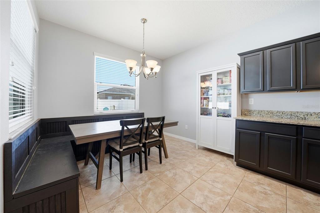 14604 Rannoch Moor Place Wimauma, FL 33598 - Photo 20 of 76 a view of a dining room with furniture and chandelier