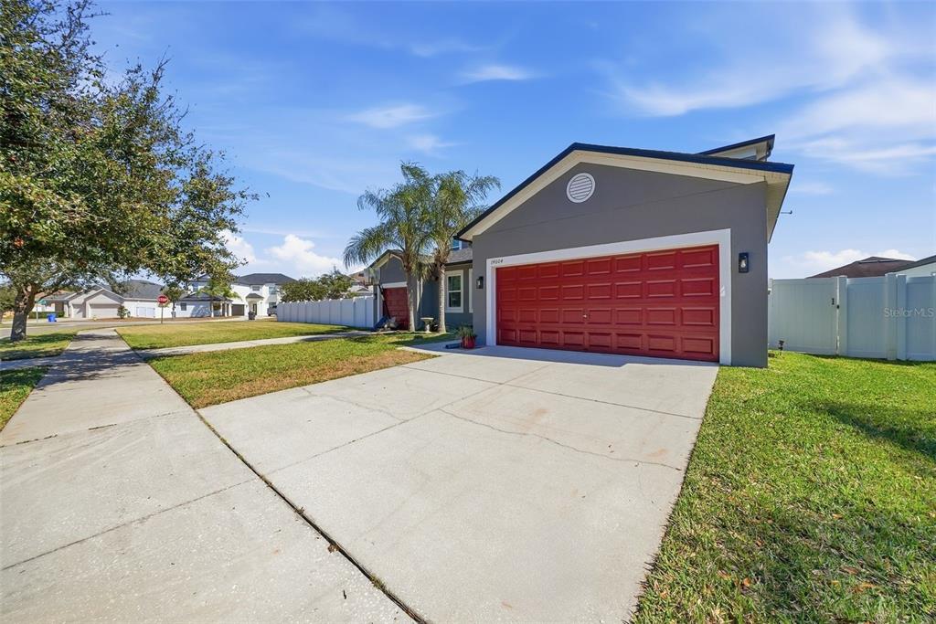 14604 Rannoch Moor Place Wimauma, FL 33598 - Photo 2 of 76 a front view of a house with a garden and garage