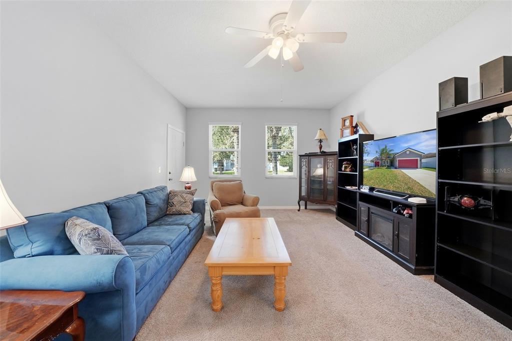 14604 Rannoch Moor Place Wimauma, FL 33598 - Photo 23 of 76 a living room with furniture and a flat screen tv
