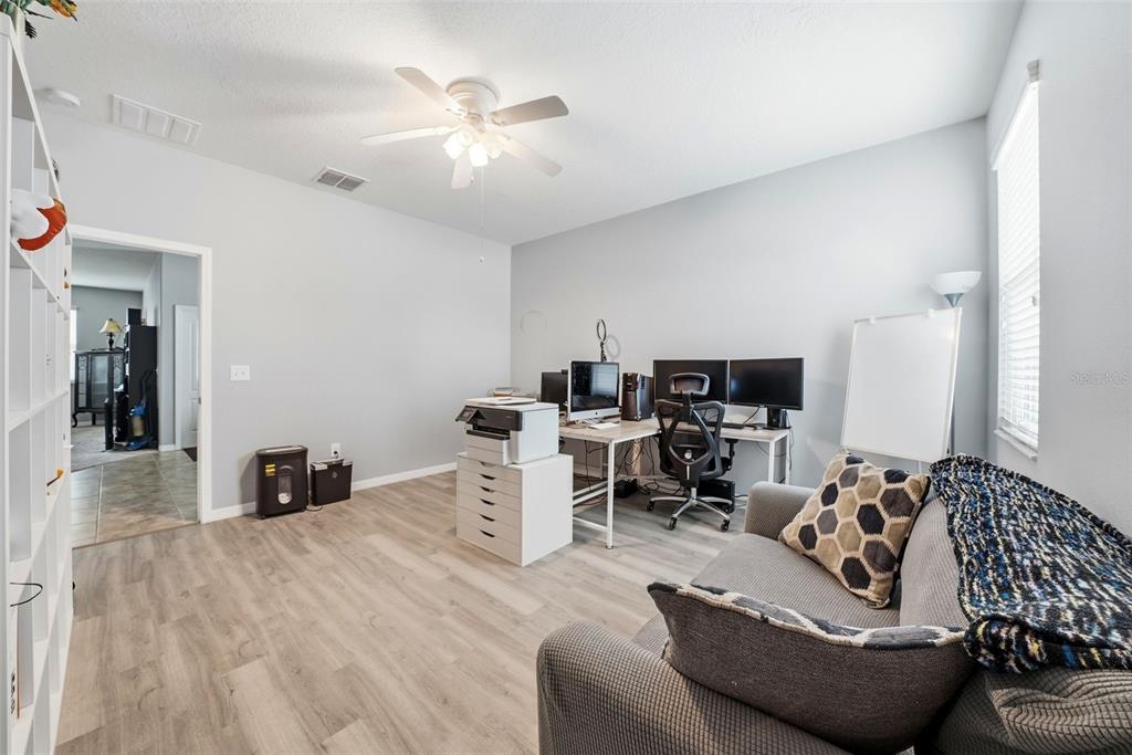 14604 Rannoch Moor Place Wimauma, FL 33598 - Photo 30 of 76 a living room with furniture and a lamp