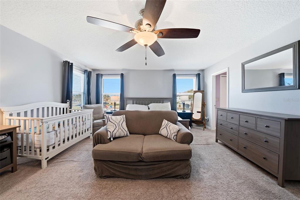 14604 Rannoch Moor Place Wimauma, FL 33598 - Photo 36 of 76 a living room with furniture and a baby crib