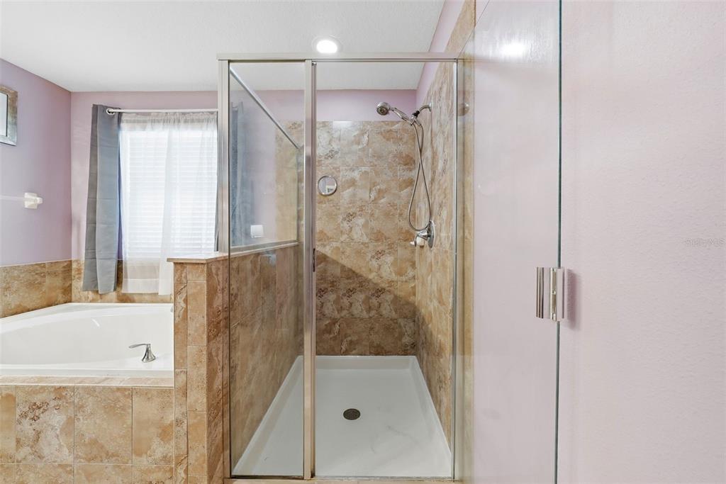 14604 Rannoch Moor Place Wimauma, FL 33598 - Photo 42 of 76 a bathroom with a bathtub and a shower