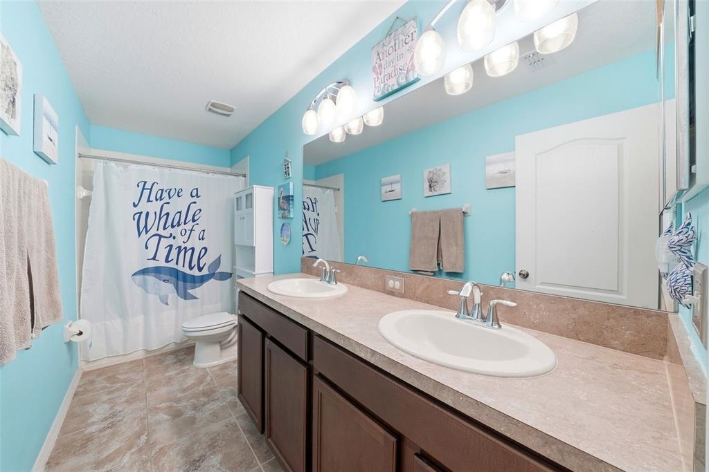 14604 Rannoch Moor Place Wimauma, FL 33598 - Photo 46 of 76 a bathroom with a sink a toilet and a mirror
