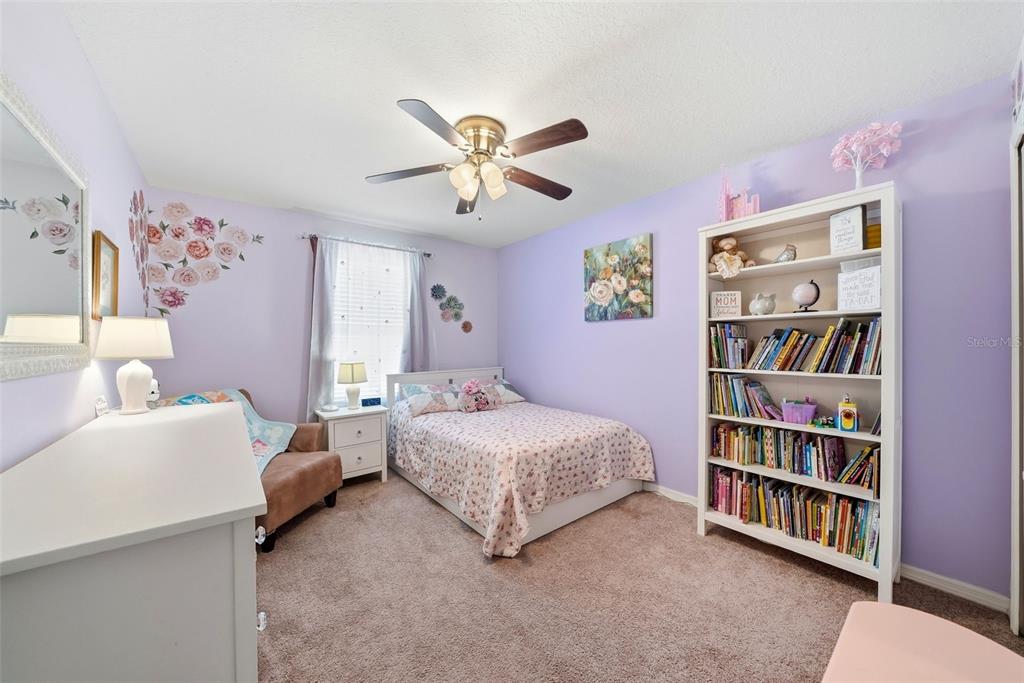 14604 Rannoch Moor Place Wimauma, FL 33598 - Photo 47 of 76 a bedroom with a bed furniture and a large window