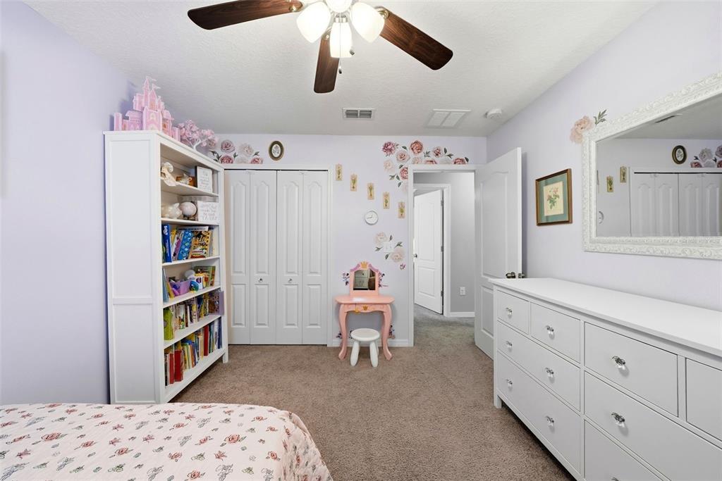 14604 Rannoch Moor Place Wimauma, FL 33598 - Photo 48 of 76 a bedroom with a bed and a cabinets