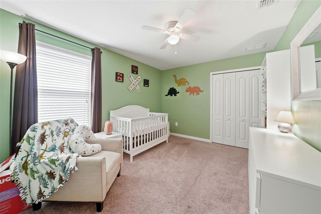 14604 Rannoch Moor Place Wimauma, FL 33598 - Photo 49 of 76 a bedroom with furniture and a large window