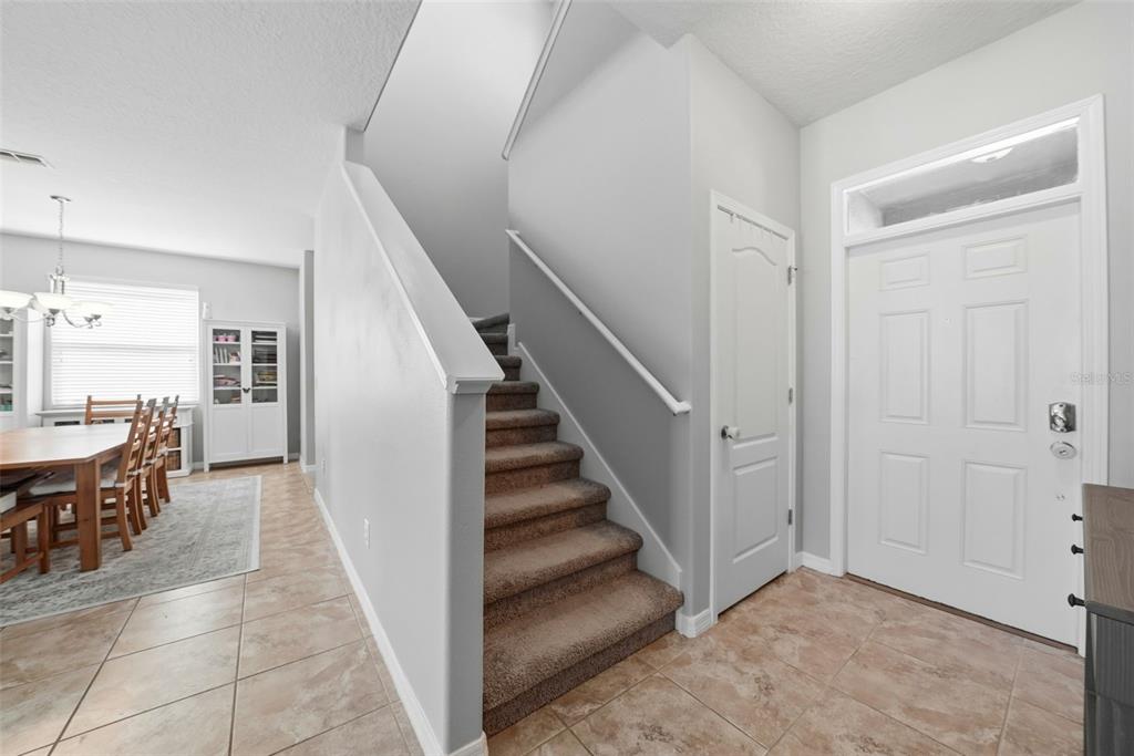 14604 Rannoch Moor Place Wimauma, FL 33598 - Photo 5 of 76 a view of a hallway with dining room and stairs
