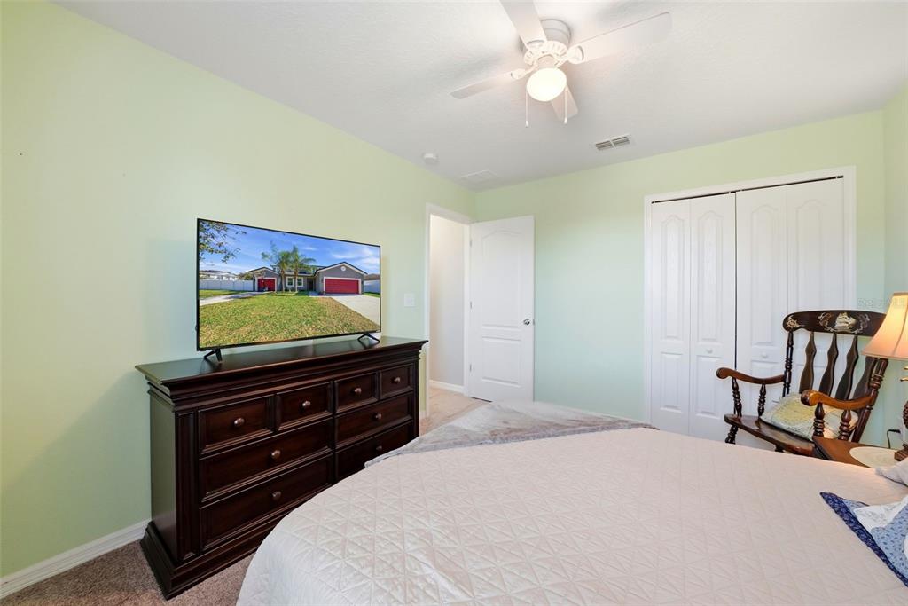 14604 Rannoch Moor Place Wimauma, FL 33598 - Photo 54 of 76 a bedroom with a bed and furniture