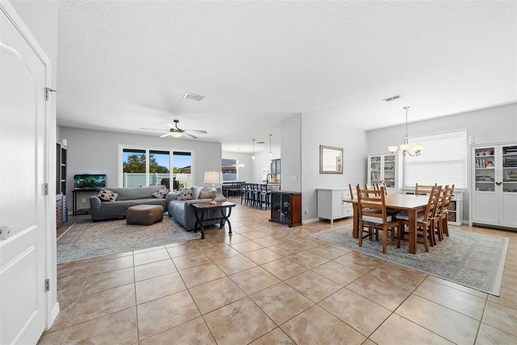 14604 Rannoch Moor Place Wimauma, FL 33598 - Photo 6 of 76 a living room with furniture and a dining table with kitchen view