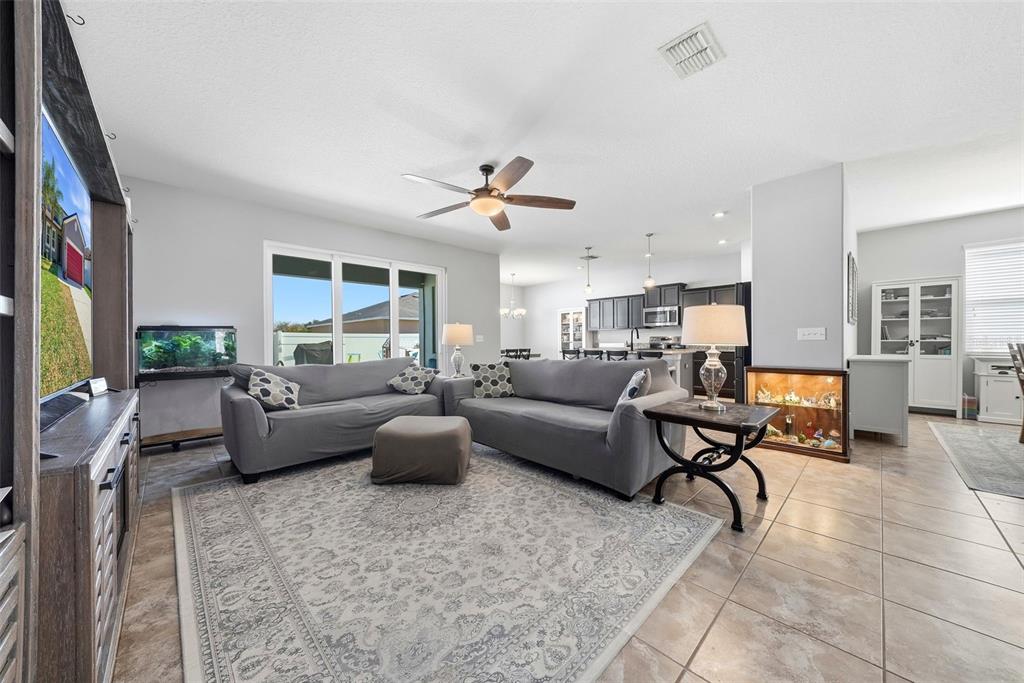 14604 Rannoch Moor Place Wimauma, FL 33598 - Photo 7 of 76 a living room with furniture and a flat screen tv
