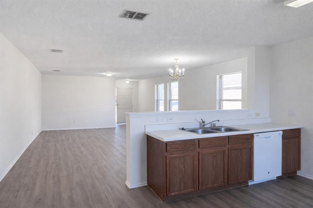 2512 Mitchell Lane Anna, TX 75409 - Photo 4 of 8 a bathroom with a granite countertop double vanity sink and mirror